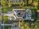 Expansive home with pool, landscaped yard, and driveway, captured in an aerial shot at 4205 Clarice Ct, Windermere, FL 34786