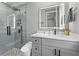 Modern bathroom featuring a glass-enclosed shower with rain shower head and a sleek vanity with marble countertop at 4205 Clarice Ct, Windermere, FL 34786