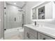 Bright bathroom featuring a tiled shower, white vanity, and modern fixtures at 4205 Clarice Ct, Windermere, FL 34786