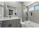 Bright bathroom features a glass-enclosed shower with rain shower head and a vanity with lighted mirror at 4205 Clarice Ct, Windermere, FL 34786