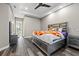 Modern bedroom with tray ceilings, hardwood floors, and gray walls offers a tranquil personal space at 4205 Clarice Ct, Windermere, FL 34786
