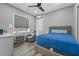 Relaxing bedroom with a gray chair, neutral walls, and a large window providing natural light at 4205 Clarice Ct, Windermere, FL 34786