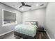 Cozy bedroom featuring wood floors, a ceiling fan, and a large window with a privacy shade at 4205 Clarice Ct, Windermere, FL 34786