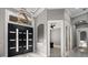 Spacious foyer with high ceilings, designer lighting, and stylish double doors leading to various rooms at 4205 Clarice Ct, Windermere, FL 34786
