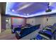 Luxury home theater with reclining seating, a projector, and adjacent hallway entrance at 4205 Clarice Ct, Windermere, FL 34786