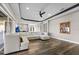Open-concept living room with a modern white sectional, dark wood floors, and recessed lighting at 4205 Clarice Ct, Windermere, FL 34786
