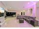 Modern living room with a leather sectional and large windows at 4205 Clarice Ct, Windermere, FL 34786