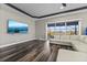 Spacious living room with dark wood floors, a large TV, and a comfortable white sectional sofa at 4205 Clarice Ct, Windermere, FL 34786