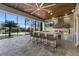 Large outdoor kitchen with bar seating, grill, and ceiling fan at 4205 Clarice Ct, Windermere, FL 34786