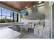 Fully-equipped outdoor kitchen with stainless steel grill, pizza oven, ample counter space, and modern finishes at 4205 Clarice Ct, Windermere, FL 34786