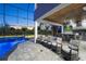 Outdoor patio area with seating and outdoor kitchen overlooking pool at 4205 Clarice Ct, Windermere, FL 34786