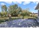 A sunny backyard with a concrete patio area and an array of chairs, great for outdoor living and entertaining at 5719 Meridian Way, Orlando, FL 32808