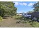 Spacious backyard with lush green grass, trees, storage shed and plenty of space for outdoor activities at 5719 Meridian Way, Orlando, FL 32808