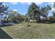 Expansive backyard with mature trees providing shade, plus a storage shed and room to roam at 5719 Meridian Way, Orlando, FL 32808