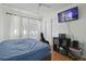Cozy bedroom with a blue bed, a tv, and ample closet space at 5719 Meridian Way, Orlando, FL 32808