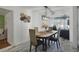 Charming dining area with a wooden table, upholstered chairs, and decorative wall accents at 5719 Meridian Way, Orlando, FL 32808