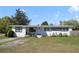 Inviting single-story home with white exterior, black trim, and landscaped front yard at 5719 Meridian Way, Orlando, FL 32808