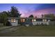 Charming single-story home with a well-maintained lawn and beautiful sunset sky at 5719 Meridian Way, Orlando, FL 32808