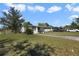 Well-maintained front yard with a single-story home and ample green space at 5719 Meridian Way, Orlando, FL 32808