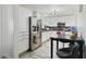 Bright kitchen featuring white cabinetry, stainless steel appliances, and a modern black countertop at 5719 Meridian Way, Orlando, FL 32808