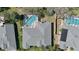 Aerial view of a home featuring a screened-in pool and well-maintained roof at 5776 Falling Tree Ln, Port Orange, FL 32127
