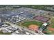 Aerial view featuring an expansive school and sports complex with baseball and tennis facilities at 5776 Falling Tree Ln, Port Orange, FL 32127