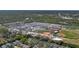 Wide aerial view of a school complex with athletic fields, parking, and residential homes nearby at 5776 Falling Tree Ln, Port Orange, FL 32127