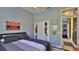 Stylish bedroom featuring baseball caps hanging on the closet door with view to connecting room at 5776 Falling Tree Ln, Port Orange, FL 32127