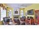 Cozy living room featuring a fireplace, ceiling fan, and comfortable seating at 5776 Falling Tree Ln, Port Orange, FL 32127
