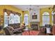 Bright living room features fireplace and lots of natural light at 5776 Falling Tree Ln, Port Orange, FL 32127