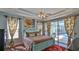 Main bedroom with ceiling fan and outside access to the pool at 5776 Falling Tree Ln, Port Orange, FL 32127