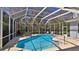 Inviting screened-in pool area with beautiful landscaping, creating a private backyard oasis at 5776 Falling Tree Ln, Port Orange, FL 32127
