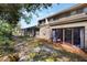 Backyard view of sliding doors to patio area and lush greenery surrounding the property at 643 Woodridge Dr, Fern Park, FL 32730