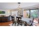 Open-concept dining room with modern lighting, a sleek table, and easy access to the living area and outdoor space at 643 Woodridge Dr, Fern Park, FL 32730
