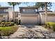 Charming townhouse featuring a two-car garage and beautiful landscaping in a well-maintained community at 643 Woodridge Dr, Fern Park, FL 32730