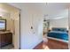 Hallway view to main bedroom and bathroom featuring tile and hardwood flooring at 643 Woodridge Dr, Fern Park, FL 32730