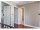 Hallway view featuring hardwood floors, neutral paint colors and staircase with dark metal railing at 643 Woodridge Dr, Fern Park, FL 32730