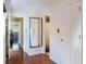 Bright hallway with hardwood floors, mirror, and access to rooms at 643 Woodridge Dr, Fern Park, FL 32730