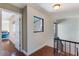 Bright hallway with wood floors, black railing and trim, and bedroom access for easy living at 643 Woodridge Dr, Fern Park, FL 32730