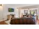 Comfortable living room with a large leather sofa, wood floors, and a flat-screen TV for relaxing evenings at 643 Woodridge Dr, Fern Park, FL 32730
