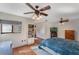 This spacious main bedroom includes two ceiling fans, a bookcase, and hardwood flooring at 643 Woodridge Dr, Fern Park, FL 32730