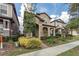 Charming two-story home featuring a stone facade, well-manicured landscaping, and inviting front porch at 7112 Enchanted Lake Dr, Winter Garden, FL 34787