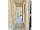 Long hallway with wood flooring and neutral-colored walls leading to bedrooms at 7112 Enchanted Lake Dr, Winter Garden, FL 34787