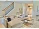 Comfortable living area with couch, tile floors, staircase and chandelier at 7112 Enchanted Lake Dr, Winter Garden, FL 34787