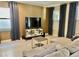 Spacious living room featuring tile floors, plush couch, and large screen tv at 7112 Enchanted Lake Dr, Winter Garden, FL 34787