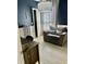 Home office with a desk, chair, and a large armchair with floor to ceiling curtains at 7112 Enchanted Lake Dr, Winter Garden, FL 34787