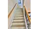 Carpeted stairway with wooden handrails, complemented by wrought iron spindles at 7112 Enchanted Lake Dr, Winter Garden, FL 34787