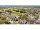 Aerial view highlights the townhome, mature trees, and proximity to a golf course for outdoor recreation at 7512 Seven Eagles Way # 7512, Reunion, FL 34747