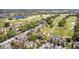 Stunning aerial view of a charming townhome community with a lush green golf course and scenic landscaping at 7512 Seven Eagles Way # 7512, Reunion, FL 34747