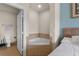 Bathroom next to bedroom features a corner tub with tiled surround at 7512 Seven Eagles Way # 7512, Reunion, FL 34747